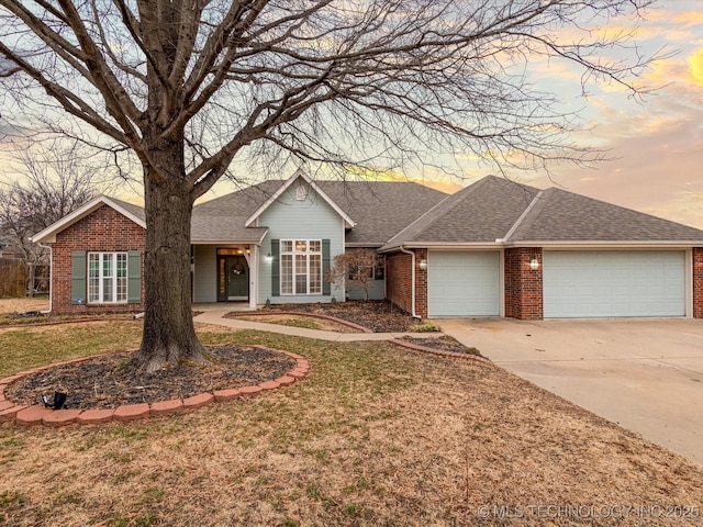 ranch-style home featuring an attached garage, roof with shingles, concrete driveway, and brick siding