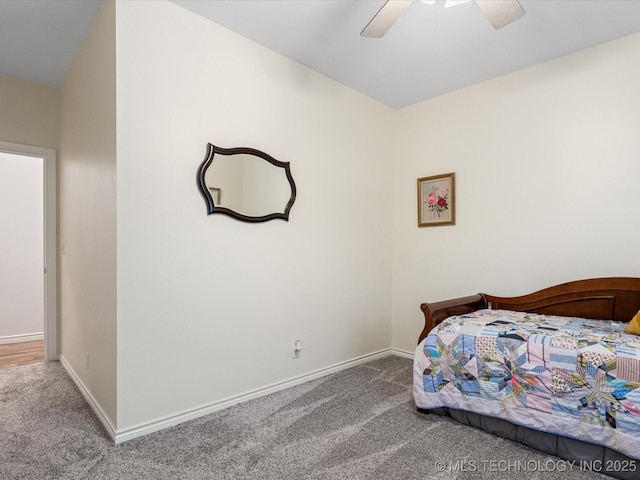 carpeted bedroom with ceiling fan and baseboards