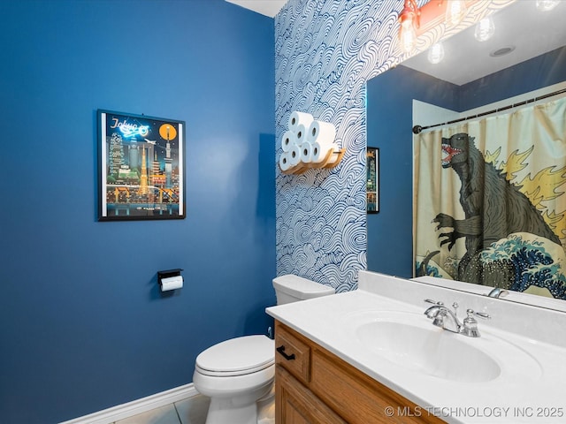 full bathroom featuring vanity, a shower with curtain, toilet, tile patterned floors, and baseboards