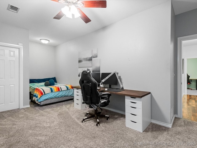 carpeted bedroom with baseboards, a ceiling fan, and visible vents