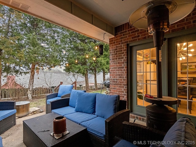 view of patio with an outdoor living space and fence