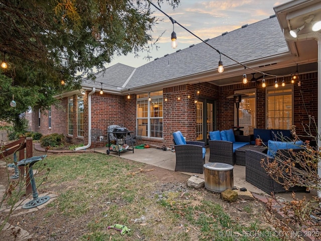back of house with a patio, roof with shingles, outdoor lounge area, brick siding, and a lawn