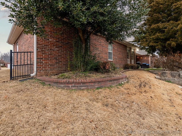 view of side of home featuring brick siding