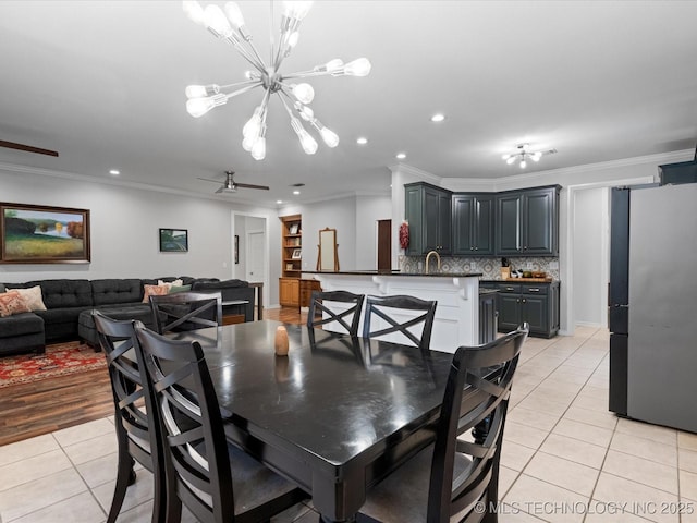dining area with crown molding, light tile patterned flooring, and an inviting chandelier