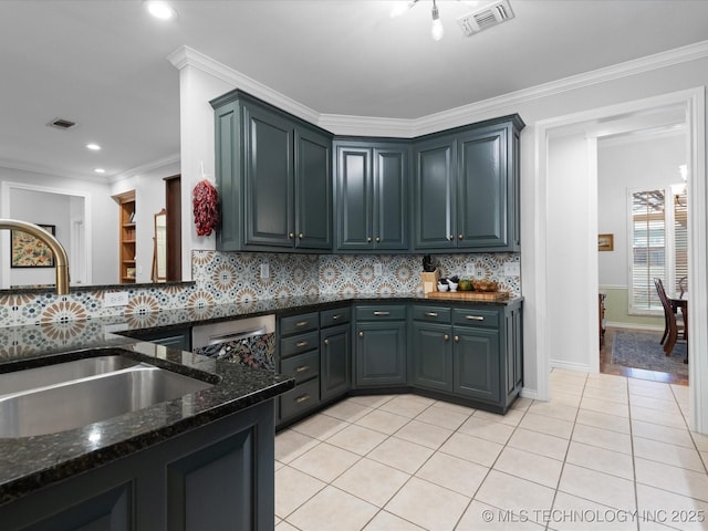 kitchen featuring dark stone counters, light tile patterned floors, a sink, and visible vents
