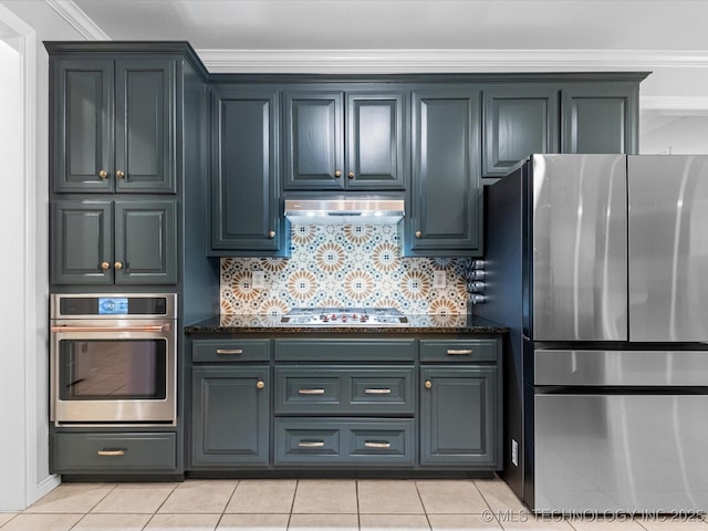 kitchen with stainless steel appliances, under cabinet range hood, backsplash, and dark stone counters
