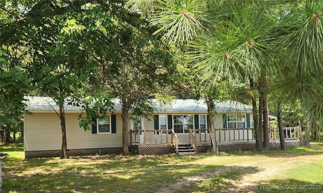 back of house featuring a wooden deck and a lawn