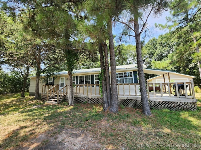 rear view of house with a yard and a deck