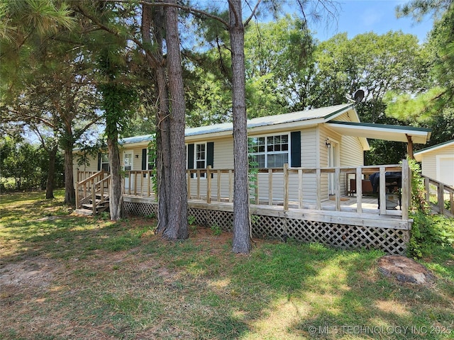 rear view of house featuring a wooden deck