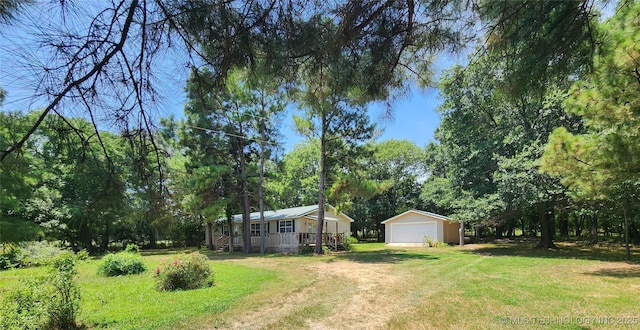 view of yard featuring an outbuilding and a garage