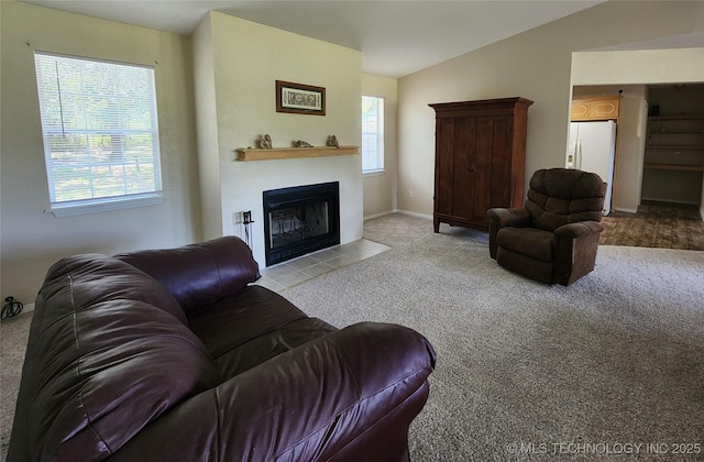 carpeted living room featuring lofted ceiling and plenty of natural light