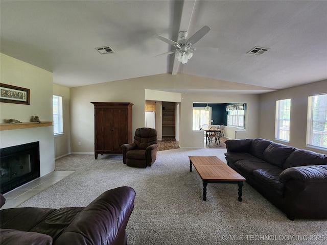 living room with vaulted ceiling with beams, light colored carpet, and ceiling fan