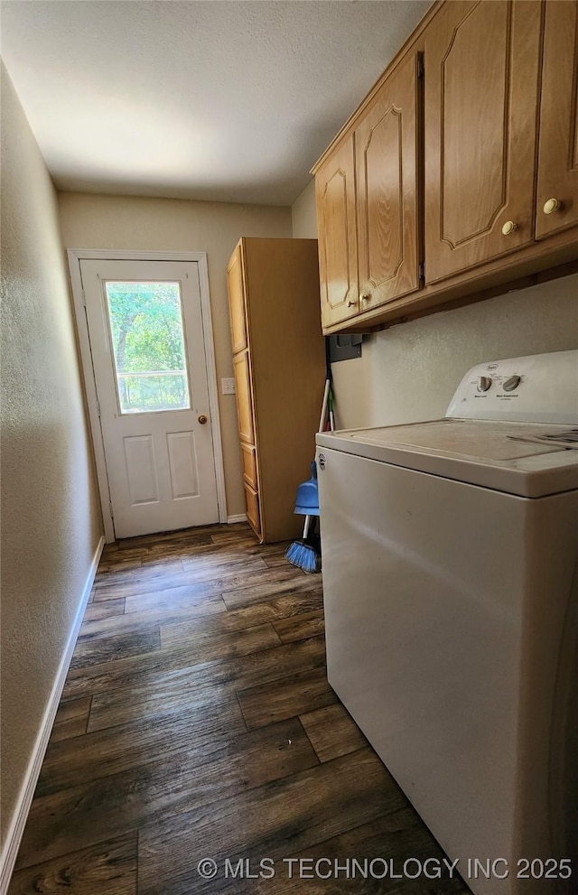 clothes washing area with dark wood-type flooring, cabinets, and washer / clothes dryer