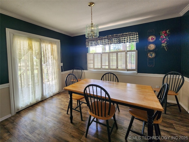 dining room with crown molding, a chandelier, and dark hardwood / wood-style flooring