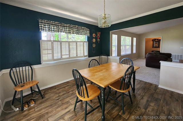 dining room with ornamental molding, lofted ceiling, and dark hardwood / wood-style flooring