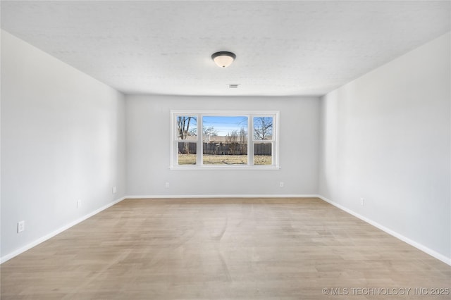 unfurnished room with light wood-type flooring