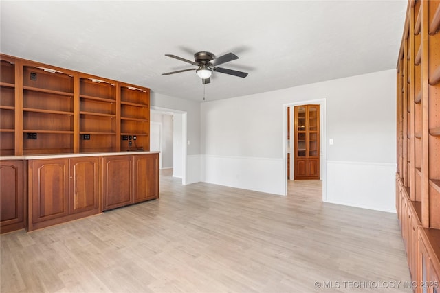 unfurnished living room featuring ceiling fan and light wood-type flooring