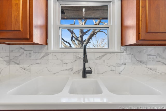 interior details with sink and decorative backsplash