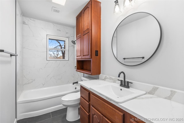 full bathroom with vanity, toilet, and tiled shower / bath combo