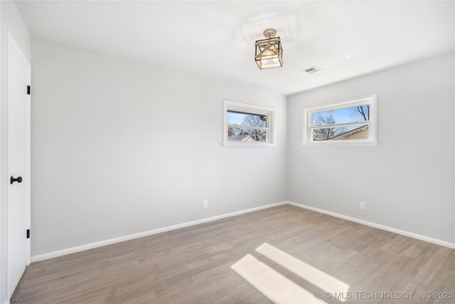 empty room with light hardwood / wood-style floors