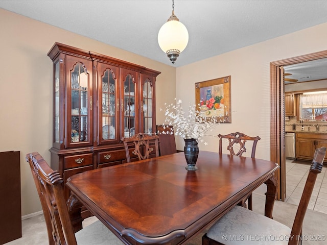 dining space with sink and light tile patterned floors