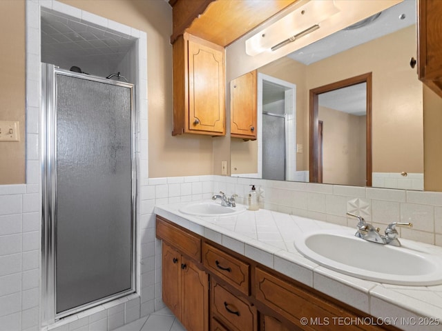 bathroom featuring vanity, tile walls, and walk in shower