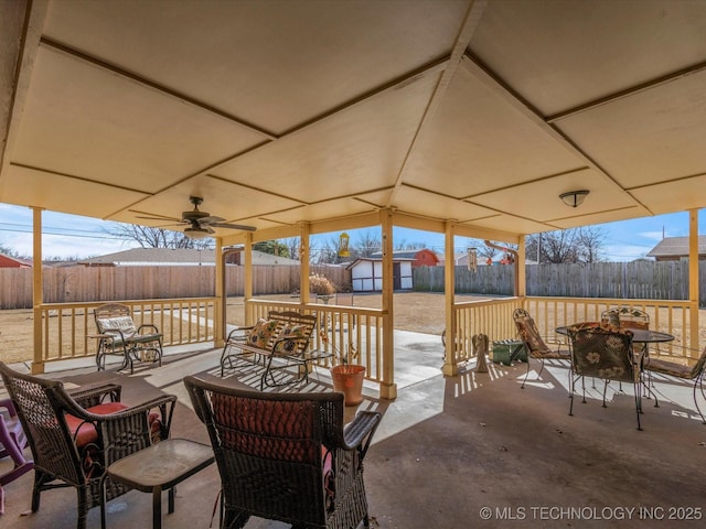 view of patio / terrace featuring ceiling fan and a storage unit