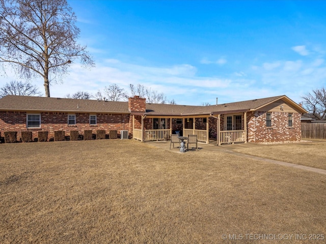 view of front of property with central AC unit, a front lawn, and a patio