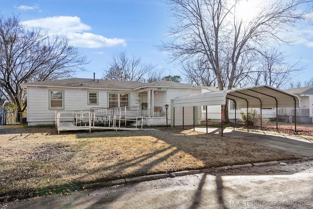 view of front facade with a wooden deck and a carport