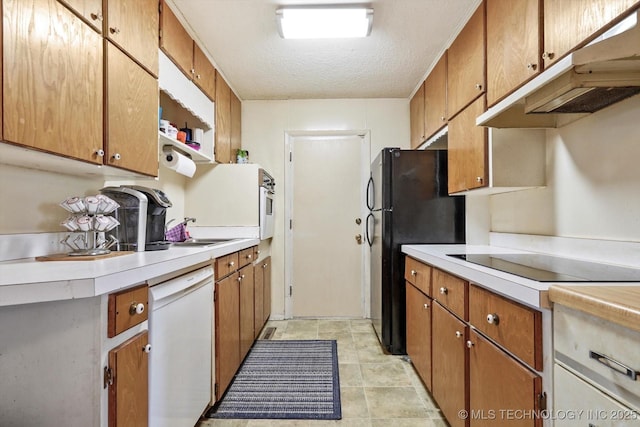 kitchen featuring sink, a textured ceiling, and black appliances