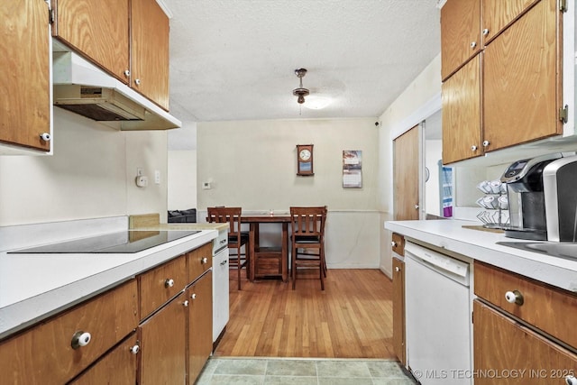 kitchen featuring white dishwasher, black electric stovetop, and a textured ceiling