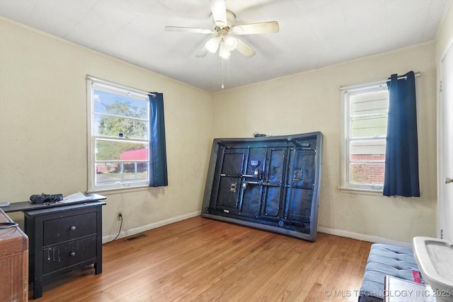 interior space with ceiling fan and light hardwood / wood-style flooring