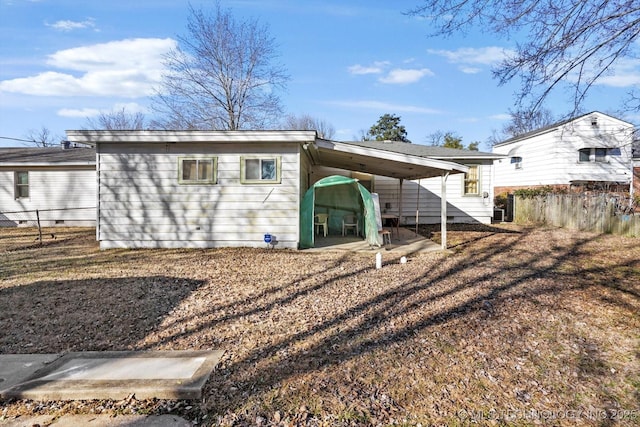 back of house with a carport