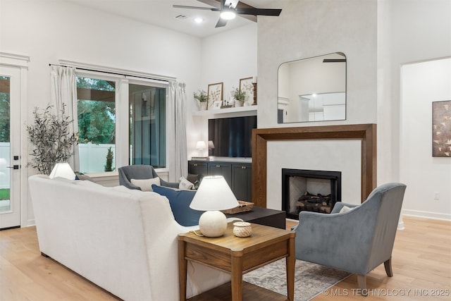 2325 E 134th Cir, Bixby, OK 74008 - living area featuring ceiling fan, a towering ceiling, light wood finished floors, and a fireplace