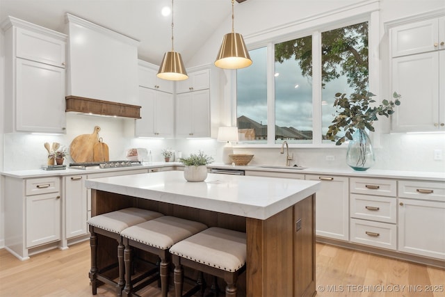 2325 E 134th Cir, Bixby, OK 74008 - kitchen featuring appliances with stainless steel finishes, light wood-type flooring, light countertops, white cabinets, and vaulted ceiling
