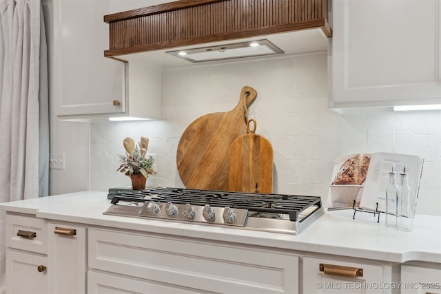 2325 E 134th Cir, Bixby, OK 74008 - kitchen featuring stainless steel gas stovetop, tasteful backsplash, and white cabinets