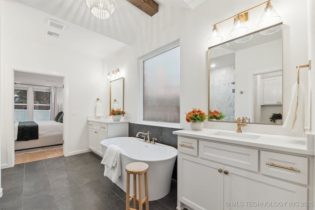 2325 E 134th Cir, Bixby, OK 74008 - full bathroom with a freestanding tub, two vanities, and connected bathroom
