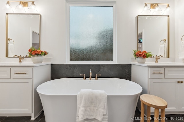2325 E 134th Cir, Bixby, OK 74008 - bathroom with plenty of natural light, two vanities, and a freestanding bath