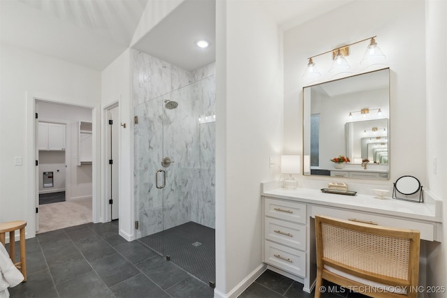 2325 E 134th Cir, Bixby, OK 74008 - bathroom with a marble finish shower, vanity, and a walk in closet
