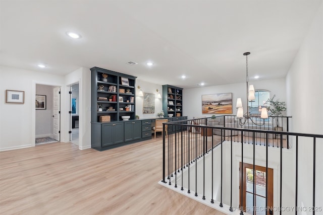 2325 E 134th Cir, Bixby, OK 74008 - hall featuring an upstairs landing, recessed lighting, light wood-style flooring, and a chandelier
