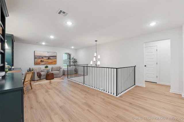 2325 E 134th Cir, Bixby, OK 74008 - corridor featuring a chandelier, light wood-style flooring, arched walkways, and recessed lighting