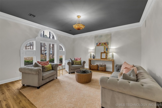 living room with hardwood / wood-style flooring and ornamental molding