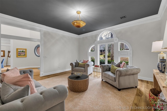 living room with crown molding and light wood-type flooring