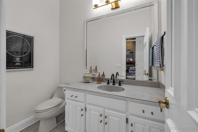 bathroom featuring vanity, tile patterned floors, and toilet