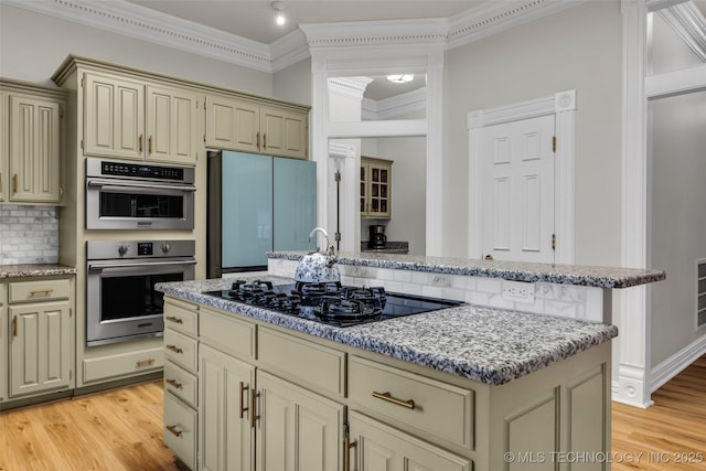 kitchen featuring fridge, a center island, light hardwood / wood-style flooring, and cream cabinetry