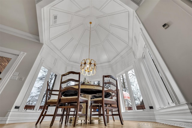 dining area featuring an inviting chandelier, ornamental molding, and a healthy amount of sunlight