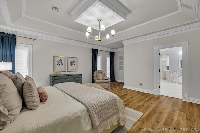 bedroom featuring multiple windows, hardwood / wood-style flooring, ornamental molding, a raised ceiling, and an inviting chandelier