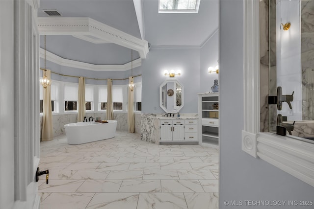 bathroom featuring ornamental molding, a bath, and vanity