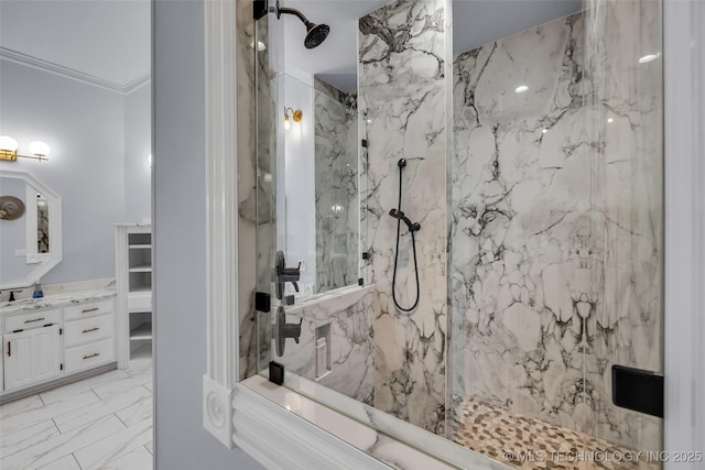 bathroom with ornamental molding, vanity, and a tile shower