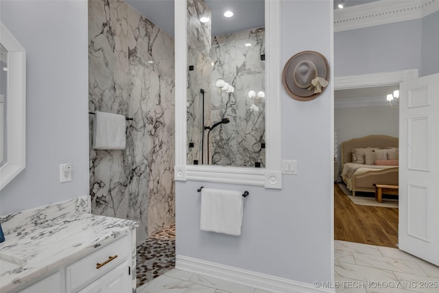 bathroom with a shower, vanity, and crown molding